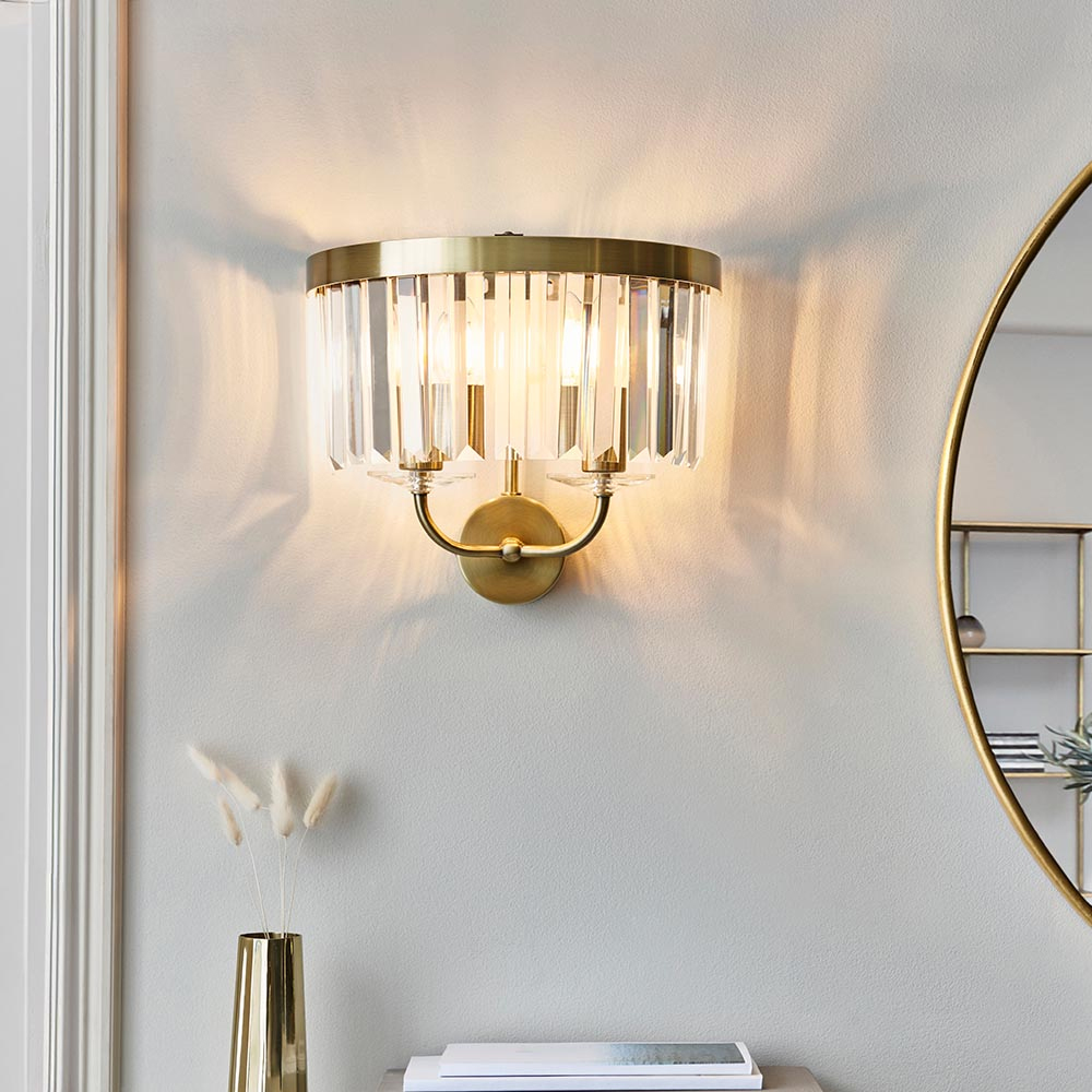 Product photograph of Allston Clear Glass Wall Light In Antique Brass from Furniture in Fashion