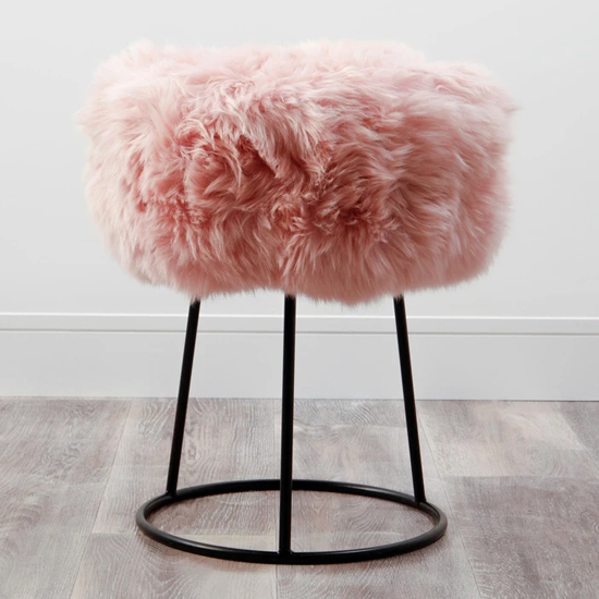 Photo of Bovril sheepskin stool with black metal legs in blush pink
