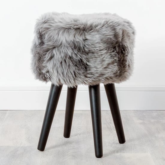 Photo of Bovril sheepskin stool with black wooden legs in grey
