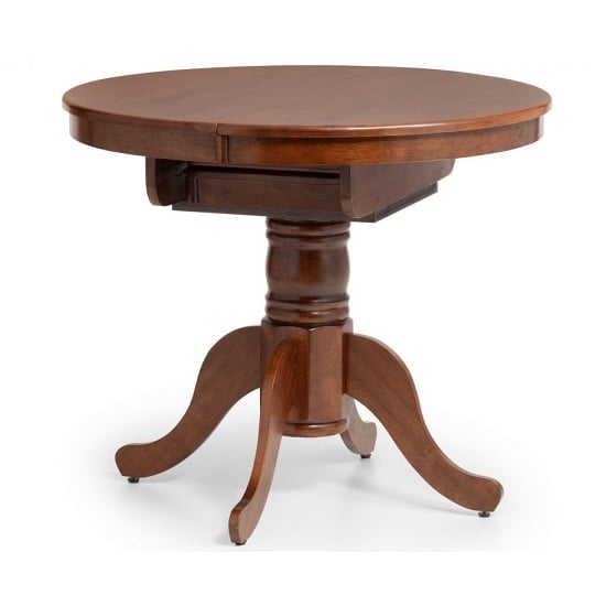 Photo of Calico extending round wooden dining table in mahogany