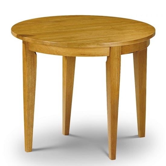Photo of Cagney round extending wooden dining table in honey pine