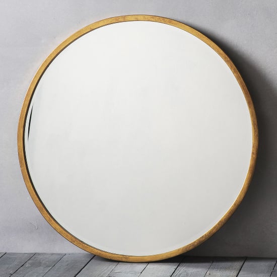 Read more about Haggen large round bedroom mirror in antique gold frame