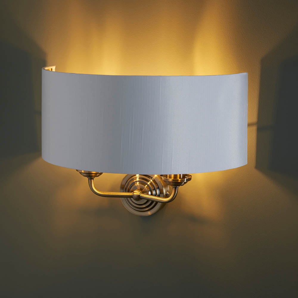 Read more about Hixson 2 light white fabric wall light in antique brass