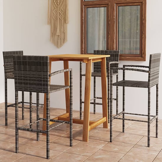 Photo of Kairi outdoor wooden bar table with 4 grey poly rattan stools