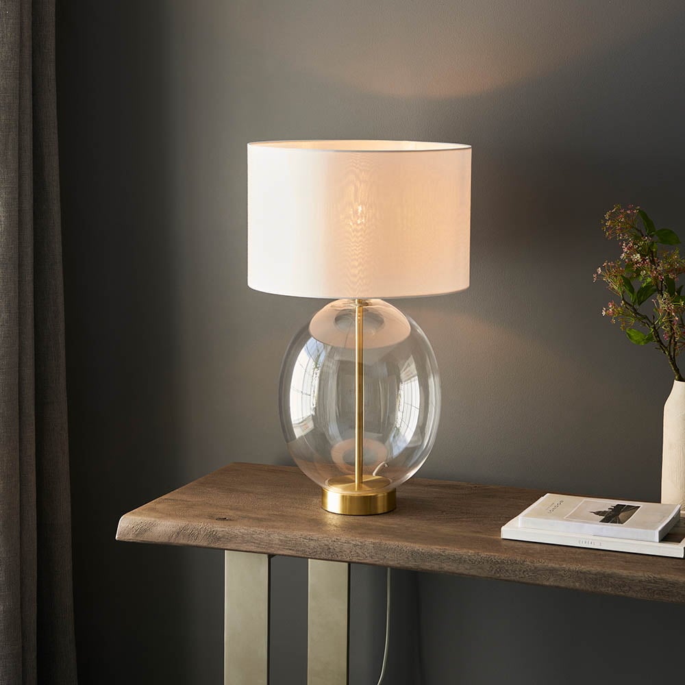 Product photograph of Katonah Oval Clear Glass Table Lamp In White And Brass from Furniture in Fashion