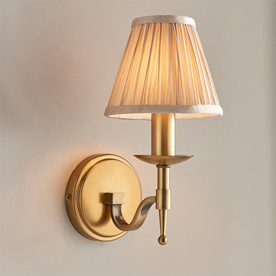Photo of Stanford single wall light in antique brass with beige shade